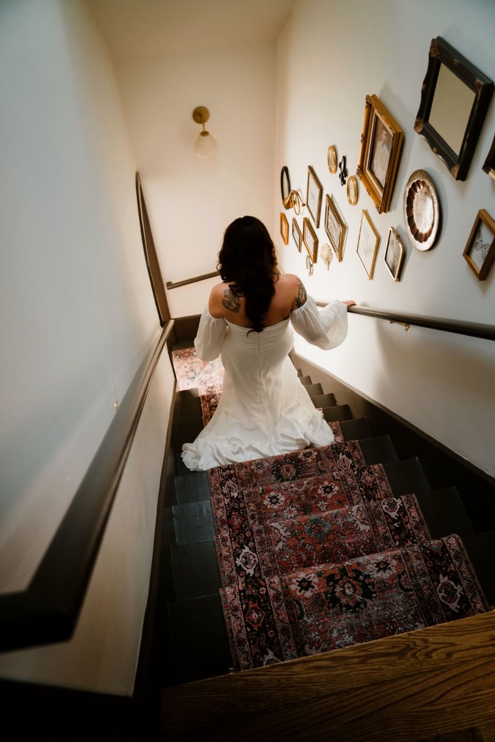 A bride descending the staircase at The Residence in her wedding dress